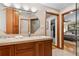Bathroom featuring double sinks, a tiled shower, and access to the main bedroom at 2520 Eldridge Cir, Golden, CO 80401