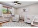 Bright bedroom with natural light, a chair, and a white crib at 2520 Eldridge Cir, Golden, CO 80401