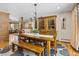 Warm dining room featuring a wooden table and chairs, chandelier, and a hutch for storing dishes and glassware at 2520 Eldridge Cir, Golden, CO 80401