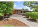 Charming front entrance with brick accents, stone pathway, and manicured greenery at 2520 Eldridge Cir, Golden, CO 80401