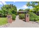 Welcoming entrance with brick pillars, well-manicured bushes, and a stone pathway at 2520 Eldridge Cir, Golden, CO 80401