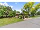 Inviting brick home with lush lawn, mature trees, and a brick entrance at 2520 Eldridge Cir, Golden, CO 80401