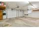 Spacious two car garage with storage shelves and overhead lighting at 2520 Eldridge Cir, Golden, CO 80401