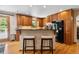 Eat in kitchen featuring warm wood cabinets, stone countertop and stainless steel appliances at 2520 Eldridge Cir, Golden, CO 80401