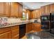 Kitchen featuring wood cabinets, modern appliances, granite countertops and warm lighting at 2520 Eldridge Cir, Golden, CO 80401