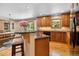 Open kitchen with breakfast bar, hardwood floors, and modern appliances at 2520 Eldridge Cir, Golden, CO 80401