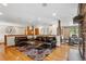 Cozy living room featuring hardwood floors, a fireplace, and access to the dining room, creating an inviting atmosphere at 2520 Eldridge Cir, Golden, CO 80401