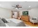Spacious main bedroom with hardwood floors, ensuite bath, and a ceiling fan at 2520 Eldridge Cir, Golden, CO 80401