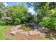 Peaceful backyard with stone-lined pond feature at 2520 Eldridge Cir, Golden, CO 80401