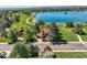 Charming home with lush trees, a red roof, and a scenic view of a serene lake at 916 W Alder St, Louisville, CO 80027