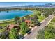 Scenic aerial view of a lakefront property with lush greenery and mountain views at 916 W Alder St, Louisville, CO 80027