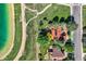 Aerial view of a property with a large yard, trees, lake access, and solar panels at 916 W Alder St, Louisville, CO 80027
