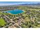 Picturesque aerial view of a neighborhood with a shimmering blue lake and mountain backdrop at 916 W Alder St, Louisville, CO 80027