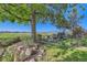 Inviting backyard featuring a mature tree, lush greenery, and views of open space at 916 W Alder St, Louisville, CO 80027