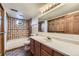 Well-lit bathroom with tub, shower, and wooden vanity at 916 W Alder St, Louisville, CO 80027