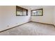 Cozy bedroom with neutral carpet, two windows with wood trim at 916 W Alder St, Louisville, CO 80027