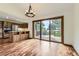 Dining room with wood floors, a modern chandelier, and sliding glass doors that lead to an outdoor deck at 916 W Alder St, Louisville, CO 80027