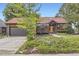 Charming front exterior showcasing brick design, a garage, and beautifully landscaped yard at 916 W Alder St, Louisville, CO 80027