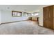 Living area with light carpet and built-in cabinetry, featuring lots of light at 916 W Alder St, Louisville, CO 80027