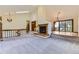 Spacious living room featuring a fireplace, carpet, and sliding glass doors to the outside at 916 W Alder St, Louisville, CO 80027
