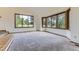 Bright living room featuring large windows, neutral carpet, and ample natural light at 916 W Alder St, Louisville, CO 80027