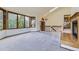 Bright living room featuring large windows, neutral carpet, and a cozy fireplace at 916 W Alder St, Louisville, CO 80027