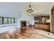 Spacious living room with wood floors, a fireplace, large windows, and stylish light fixture and cabinets at 916 W Alder St, Louisville, CO 80027