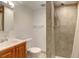 Bright bathroom featuring a tiled shower, modern sink, and toilet at 2030 Gyros Cir # 155, Lafayette, CO 80026