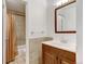 Bathroom featuring tiled shower with curtain, vanity with sink, and ample lighting above the mirror at 2030 Gyros Cir # 155, Lafayette, CO 80026