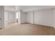 Large empty bedroom with neutral carpet, white walls, and two entryways at 2030 Gyros Cir # 155, Lafayette, CO 80026
