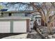 Charming townhouse featuring brick accents, a white garage door, and a neatly landscaped walkway at 2030 Gyros Cir # 155, Lafayette, CO 80026