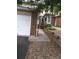 Townhouse featuring brick accents, a two-car garage, and a landscaped walkway leading to the entrance at 2030 Gyros Cir # 155, Lafayette, CO 80026