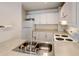 Kitchen with stainless steel sink and white appliances at 2030 Gyros Cir # 155, Lafayette, CO 80026
