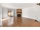 Open living area with hardwood floors, fireplace, and sliding doors at 2030 Gyros Cir # 155, Lafayette, CO 80026