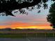 Picturesque view of a vibrant sunset over a field with distant mountains at 2030 Gyros Cir # 155, Lafayette, CO 80026