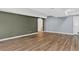 Finished basement featuring wood-look flooring and a nearby bathroom at 5926 S Elkhart Ct, Centennial, CO 80016