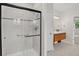 Modern bathroom with tiled shower, sleek vanity and tiled floors for a clean, updated look at 5926 S Elkhart Ct, Centennial, CO 80016