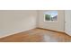 Bright bedroom with hardwood floors and a window offering natural light and neighborhood views at 5926 S Elkhart Ct, Centennial, CO 80016