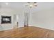 Bedroom with wooden floors, ceiling fan, and fireplace, blending comfort and style at 5926 S Elkhart Ct, Centennial, CO 80016