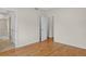 Sunlit bedroom with wooden floors connects to a closet and tiled bathroom, offering convenience and style at 5926 S Elkhart Ct, Centennial, CO 80016
