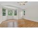 Open bedroom area with high ceilings, hardwood floors, and large bay window at 5926 S Elkhart Ct, Centennial, CO 80016