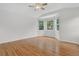 Spacious bedroom with wooden floors, a ceiling fan, and a sunny window nook at 5926 S Elkhart Ct, Centennial, CO 80016