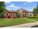 Beautiful red brick home with manicured lawn and arched entryway, creating a welcoming curb appeal at 5926 S Elkhart Ct, Centennial, CO 80016