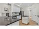 Bright kitchen boasts stainless appliances, white cabinets, and dark countertops at 5926 S Elkhart Ct, Centennial, CO 80016
