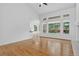 Bright, open-concept living space with hardwood floors, expansive windows, and seamless flow to the kitchen at 5926 S Elkhart Ct, Centennial, CO 80016