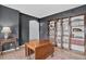 Living room with dark gray walls, light hardwood floors, and built in bookshelves at 5926 S Elkhart Ct, Centennial, CO 80016