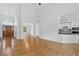 Spacious open-concept living room with hardwood floors, archways, natural light, and seamless flow to the kitchen at 5926 S Elkhart Ct, Centennial, CO 80016