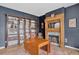 Living room with dark blue accent wall and fireplace with wood mantle at 5926 S Elkhart Ct, Centennial, CO 80016