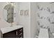 Stylish powder room with decorative wallpaper, modern mirror, and floating vanity at 5926 S Elkhart Ct, Centennial, CO 80016
