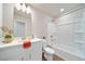 Bright bathroom featuring a white vanity, quartz countertop, and shower with white tub at 22072 E 38Th Pl, Aurora, CO 80019